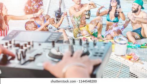 Happy Friends Drinking Champagne In Summer Boat Party - Young Millennials People Having Fun Drinking Together With Dj Mixing Music - Youth Lifestyle And Vacation Concept - Focus On Right Guys