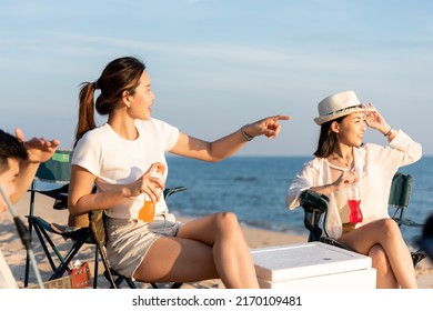 Happy friends with drinks in camp and laughing together in holidays on sand beach near camping tent vacation time at sunset, Young Asian group woman and man in summer travel outdoor - Powered by Shutterstock