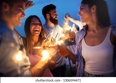 Happy Friends With Drinks Toasting At Rooftop Party At Night