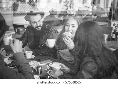 Happy Friends Eating Breakfast And Drinking Coffee With Milk In Bar Cafeteria - View Through Glass With Reflection - Black And White Editing - Focus On Bearded Man - Warm Filter