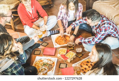 Happy Friends Eating Take Away Pizza At Home After Work - Friendship Concept With Young People Enjoying Time Together And Having Genuine Fun In Start Up Office - Focus On Beers And French Fries