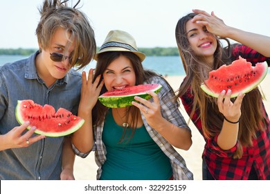 Happy Friends Eating Watermelon On The Beach. Youth Lifestyle. Happiness, Joy, Friendship, Holiday, Beach, Summer Concept. Group Of Young People Having Fun Outdoor.