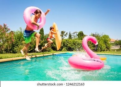 Happy friends enjoying pool party in summer - Powered by Shutterstock