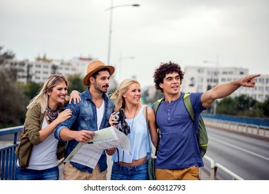 Happy friends enjoying sightseeing tour in the city.