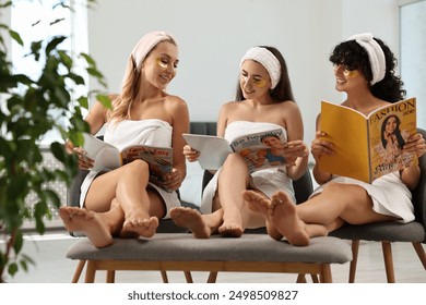 Happy friends with eye patches reading magazines indoors. Spa party - Powered by Shutterstock