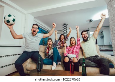 Happy Friends Or Football Fans Watching Soccer On Tv And Celebrating Victory At Home.Friendship, Sports And Entertainment Concept.