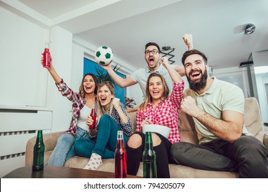 Happy Friends Or Football Fans Watching Soccer On Tv And Celebrating Victory At Home.Friendship, Sports And Entertainment Concept.