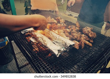 Happy Friends Gathering And Enjoying Barbecue Concept At Backyard During Night.variety Of Marinated Meal Grilled With Charcoal 