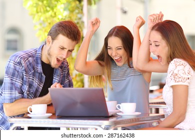 Happy Friends Giving A Laptop Gift To A Surprised Girl In A Coffee Shop