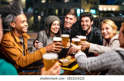 Happy friends group drinking beer at brewery bar out doors - Friendship lifestyle concept with young people enjoying time together at open air pub - Powered by Shutterstock