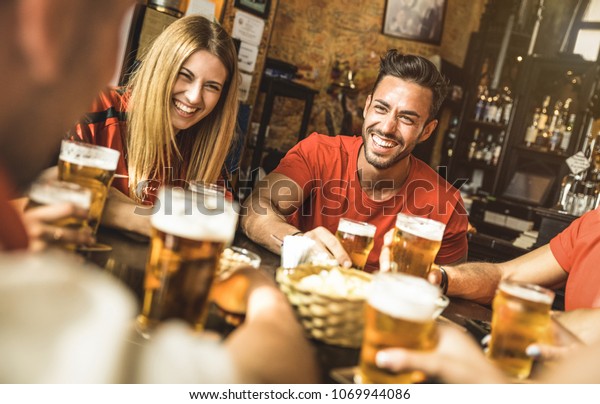 Happy friends group drinking beer at brewery bar\
restaurant - Friendship concept with young people enjoying time\
together and having genuine fun at cool vintage pub - Focus on guy\
- High iso image