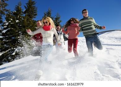 happy friends have fun at winter on fresh snow, healthy young people group outdoor Foto Stock