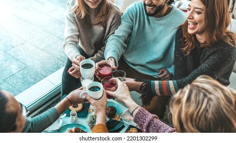 Happy friends having breakfast together at cafe bar - Group of young people drinking coffee and fresh juice sitting at brunch restaurant - Food and drink concept - Powered by Shutterstock