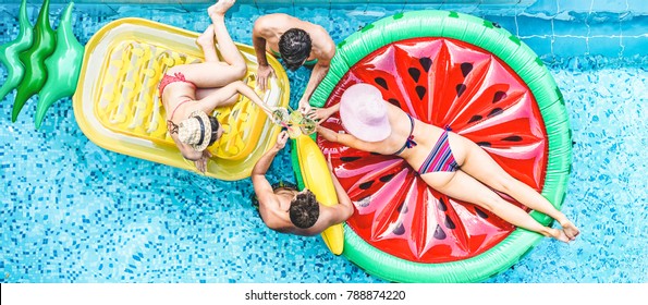 Happy Friends Having Cheering With Cocktails In Swimming Pool Party - Young People Enjoying Summer Holidays Vacation In Tropical Hotel Resort - Travel, Holidays, Youth And Friendship Concept