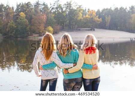 Happy friends having fun in beautiful autumn park. Pretty women in fall time