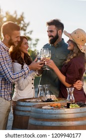 Happy Friends Having Fun Drinking Wine At Winery Vineyard - Friendship Concept With Young People Enjoying Harvest Time Together