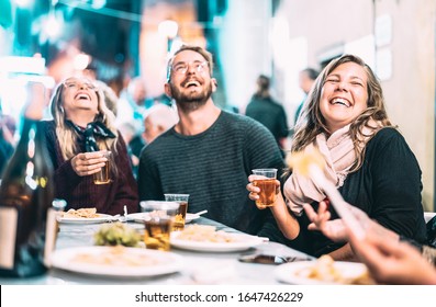 Happy Friends Having Fun Drinking White Wine At Street Festival - Young People Eating Local Food At Open Air Restaurant Together - Dinning Lifestyle Concept On String Light Neon Filter