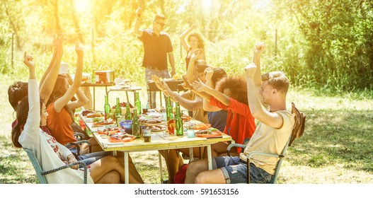 Happy Friends Having Fun Eating At Barbecue Party Outdoor Big House Backyard Garden - Young Diverse Culture People Enjoying Bbq Lunch - Friendship And Grill Concept - Focus On Two Bottom Guys