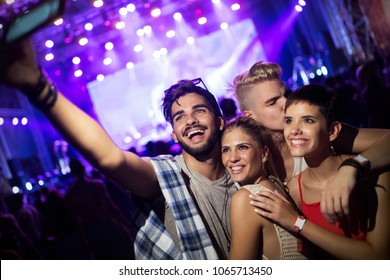 Happy friends having fun at music festival - Powered by Shutterstock