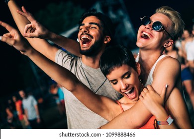 Happy friends having fun at music festival - Powered by Shutterstock