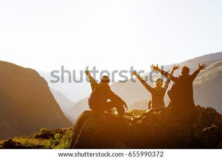 Happy friends having fun at sunset time in mountains range backdrop. Space for text