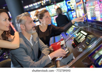 Happy Friends Having Fun Together With Slot Machine