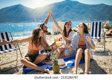 Happy friends having fun with tropical cocktails on beach party. Travel and summer vacation concept. - Powered by Shutterstock