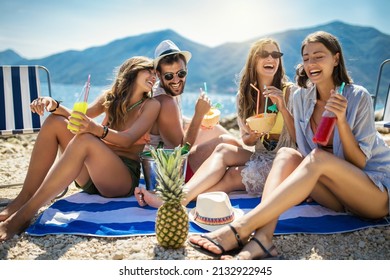 Happy friends having fun with tropical cocktails on beach party. Travel and summer vacation concept. - Powered by Shutterstock