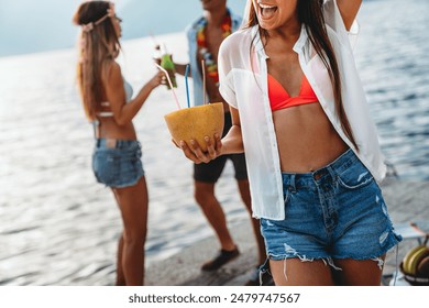 Happy friends having fun with tropical cocktails on beach party. Travel and summer vacation concept. - Powered by Shutterstock