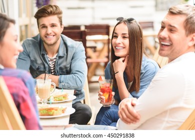 Happy Friends Having Lunch In Cafe