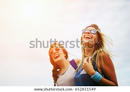 Happy friends laughing and smiling outdoors