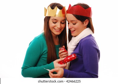 Happy Friends Looking At Joke From Christmas Cracker On White Background