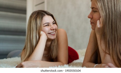 Happy friends lying in bed and talking and laughing - Powered by Shutterstock