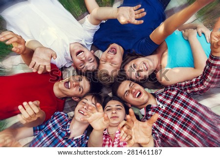 Similar – Young people with their heads together having fun