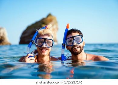 Happy friends men enjoying summer vacation and scuba diving - Powered by Shutterstock