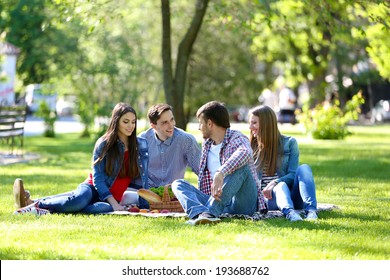 Happy Friends On Picnic In Park