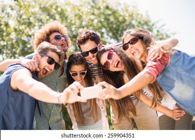 Happy Friends In The Park Taking Selfie On A Sunny Day