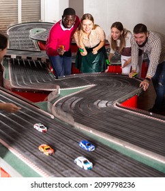 Happy Friends Play Together With Slot Car Racing At Playroom