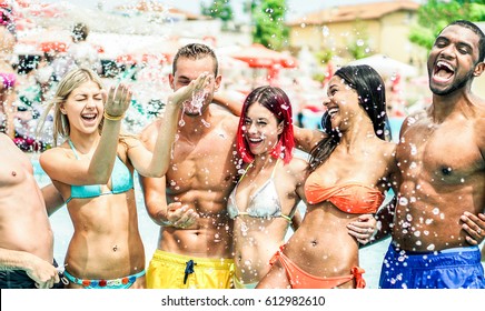 Happy Friends Playing In Swimming Pool Party - Young Diverse Culture People Having Fun On Summer Vacation - Main Focus On Center Guys - Youth And Friendship Concept - Warm Contrast Filter