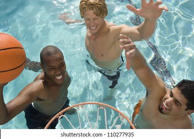 Happy friends playing water basketball in pool - Powered by Shutterstock