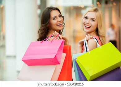 Happy Friends Shopping. Two Beautiful Young Women Enjoying Shopping At Shopping Mall