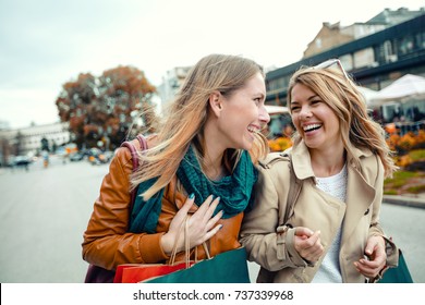 Happy Friends Shopping. Two Beautiful Young Women Enjoying Shopping In The City.