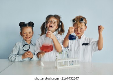 Happy friends smiling. Children in white coats plays a scientists in lab by using equipment. - Powered by Shutterstock