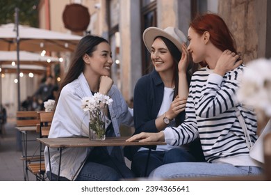 Happy friends spending time together in outdoor cafe - Powered by Shutterstock