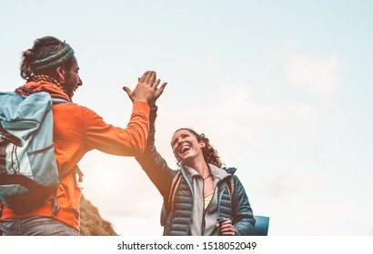 Happy Friends Stacking Hands While Doing Trekking Excursion On Mountain - Young Tourists Walking And Exploring The Wild Nature - Trekker, Team, Hike And Travel People Concept