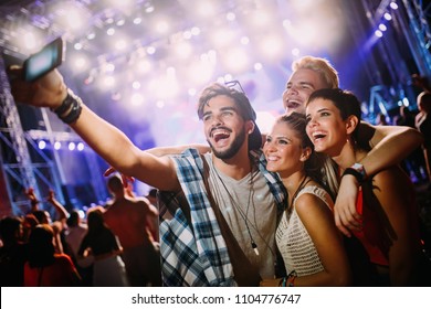 Happy Friends Taking Selfie At Music Festival