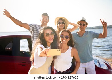 Happy Friends Taking Selfie Near Car On Beach. Summer Trip