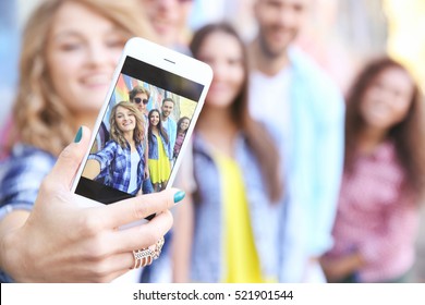 Happy Friends Taking Selfie On Street