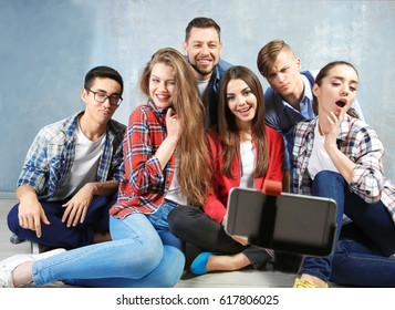 Happy friends taking selfie while sitting on floor indoors - Shutterstock ID 617806025