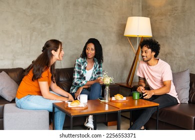 happy friends talking and enjoying snack in coffee shop